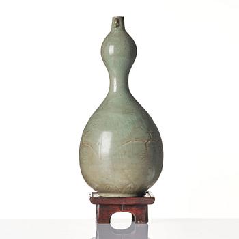 A Korean Celadon glazed double gourd bottle, Koryo dynasty, 12/13th century.