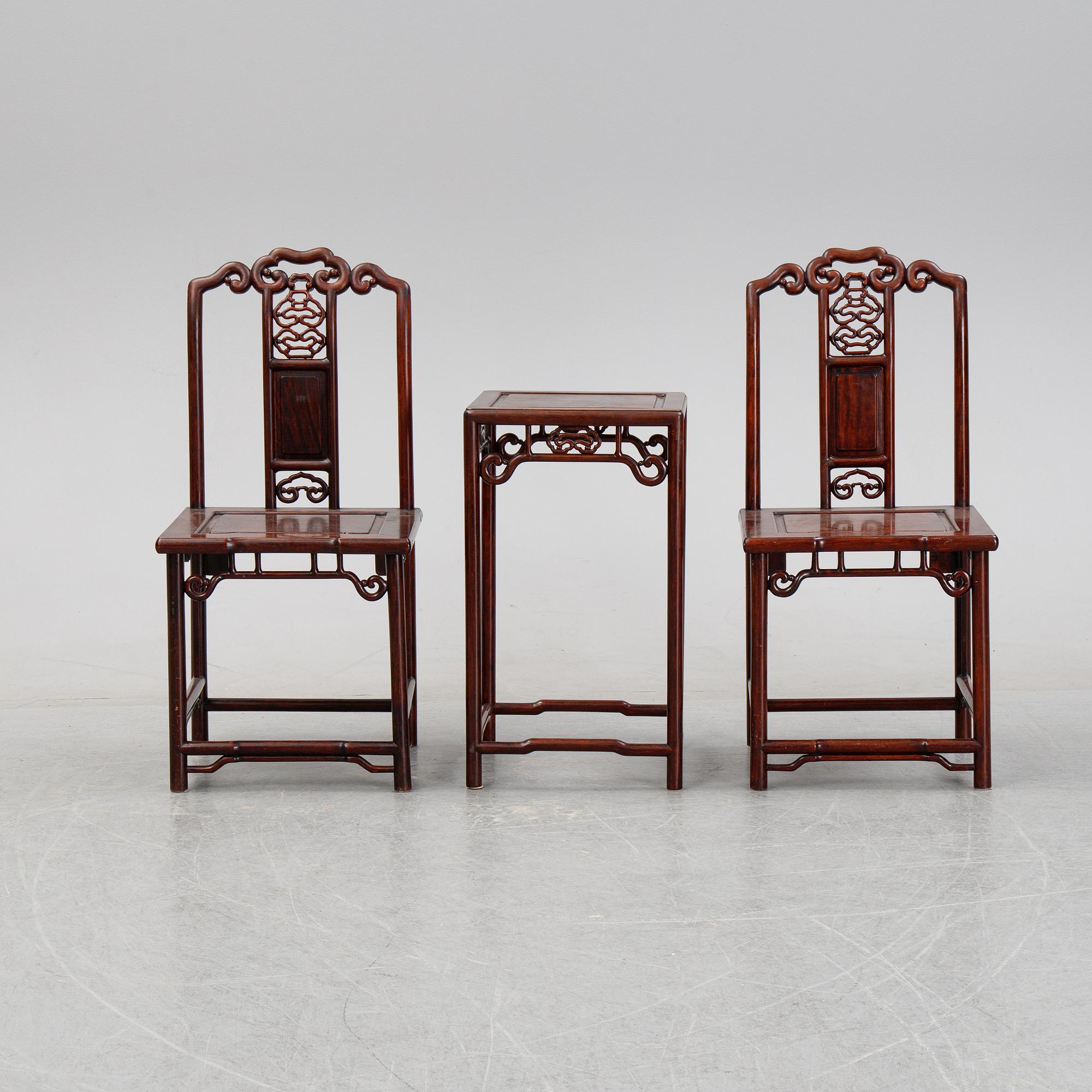 A pair of Chinese hardwood contemporary chairs and table.