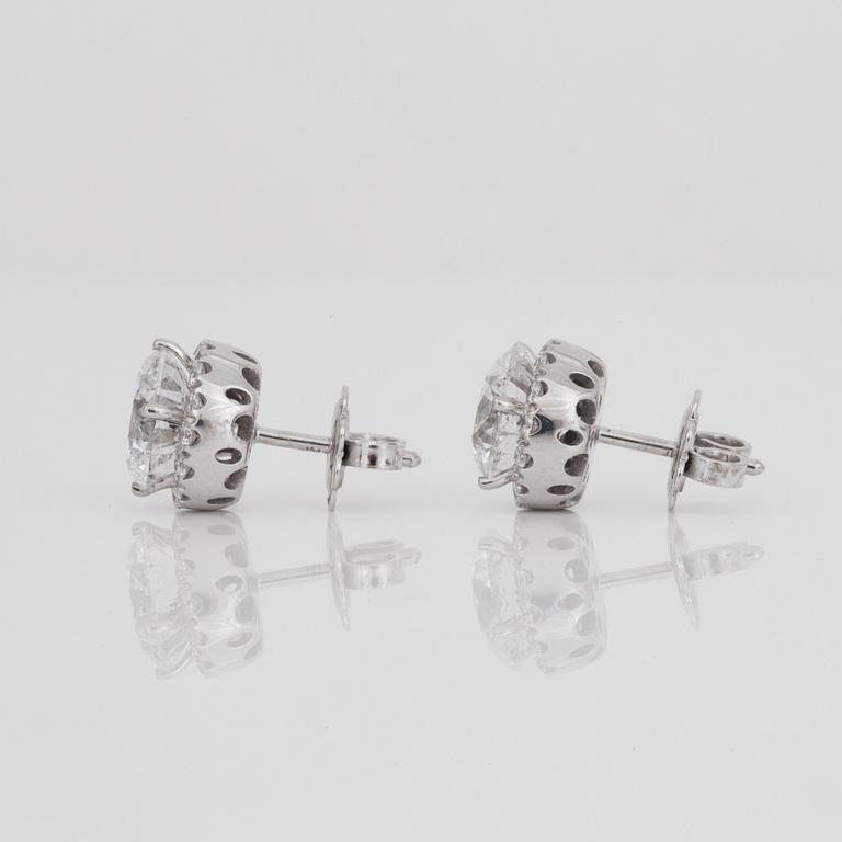 A pair of brilliant-cut diamond earrings. 2.07 cts and 2.11 cts, D-E/SI2, according to certificates from HRD and IGI.