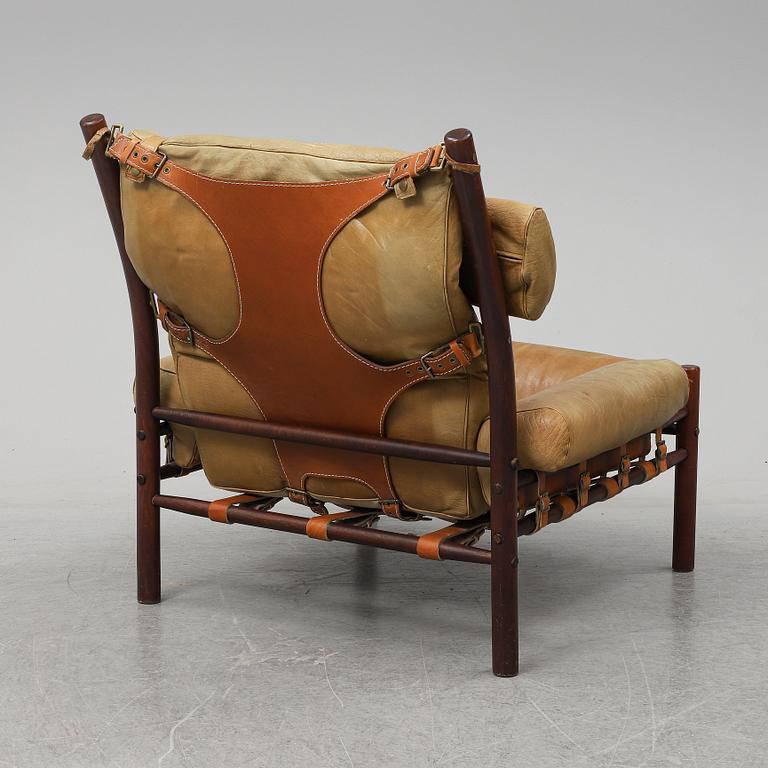 AN ARNE NORELL "INCA" LOUNGE CHAIR.