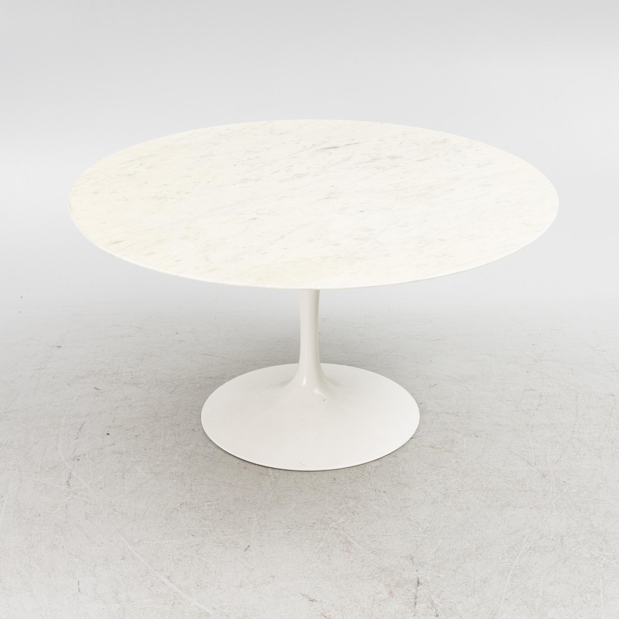 Eero Saarinen, a "Tulip" dining table with four chairs, 1970's.