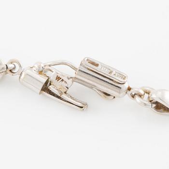 Necklace in 18K white gold with a white stone likely rock crystal and round brilliant-cut diamonds, in the shape of an elephant.