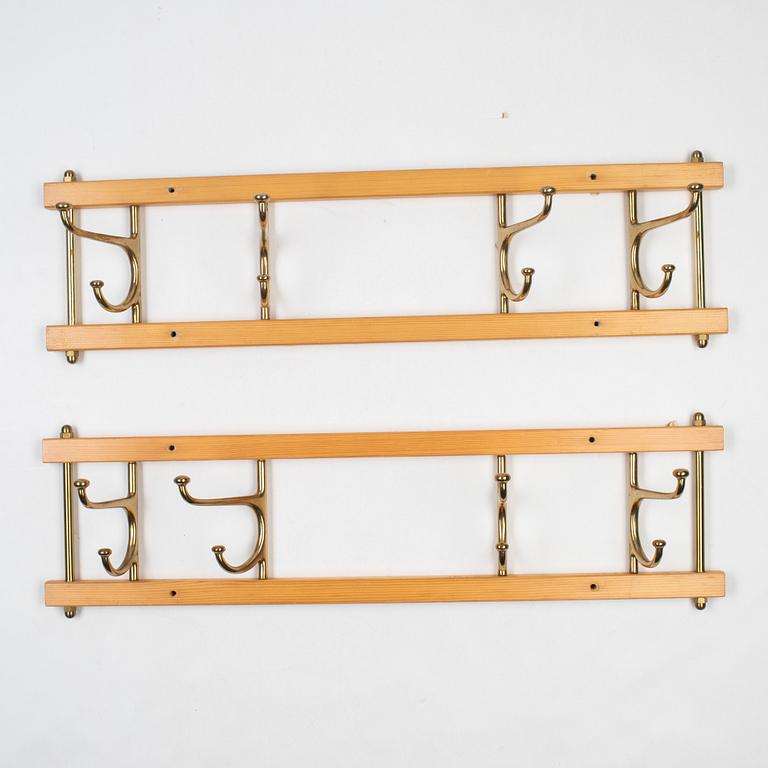 A pair of 'Dekorativ' coat hangers, Skoglunds metallgjuteri, Anderstorp, mid 20th Century.