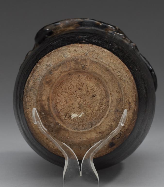 A black and brown glazed jar with a dragon in relief, Song dynasty (960-1279).