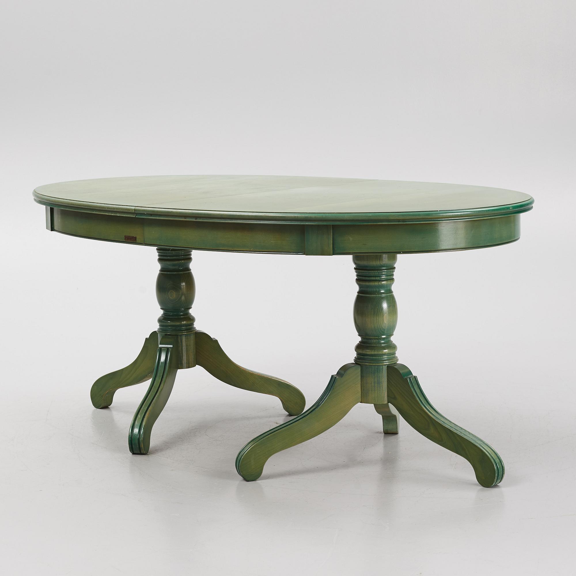 A dining table with eight chairs, Grange, France, late 20th century.