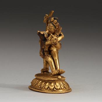 A Tibetan gilt bronze figure of Yab Yum, presumably circa 1900.