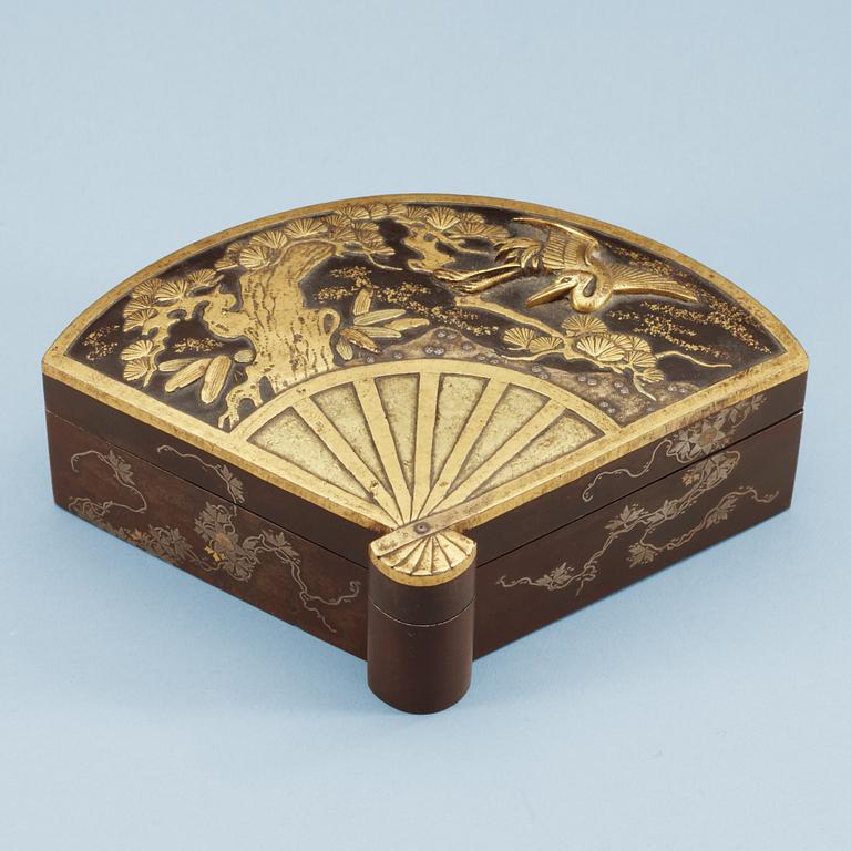 A Japanese fan-shaped gilt and silvered bronze box with cover, Meiji, circa 1900.