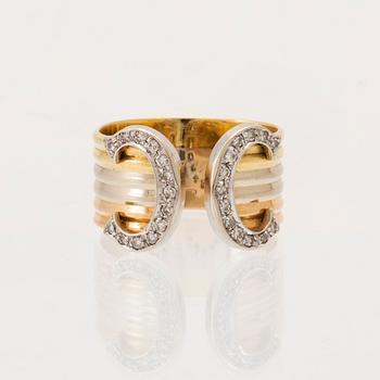 A Cartier "Double C" ring 18K tricolor gold set with round single-cut diamonds.