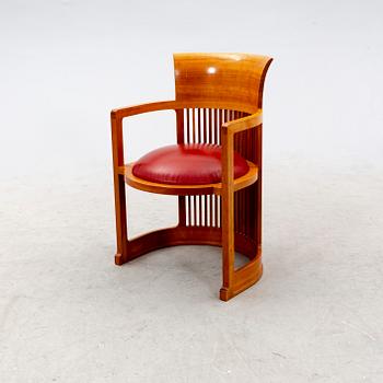 A cherry wood model 606 'Barrel' chair by Frank Lloyd Wright from Cassina.