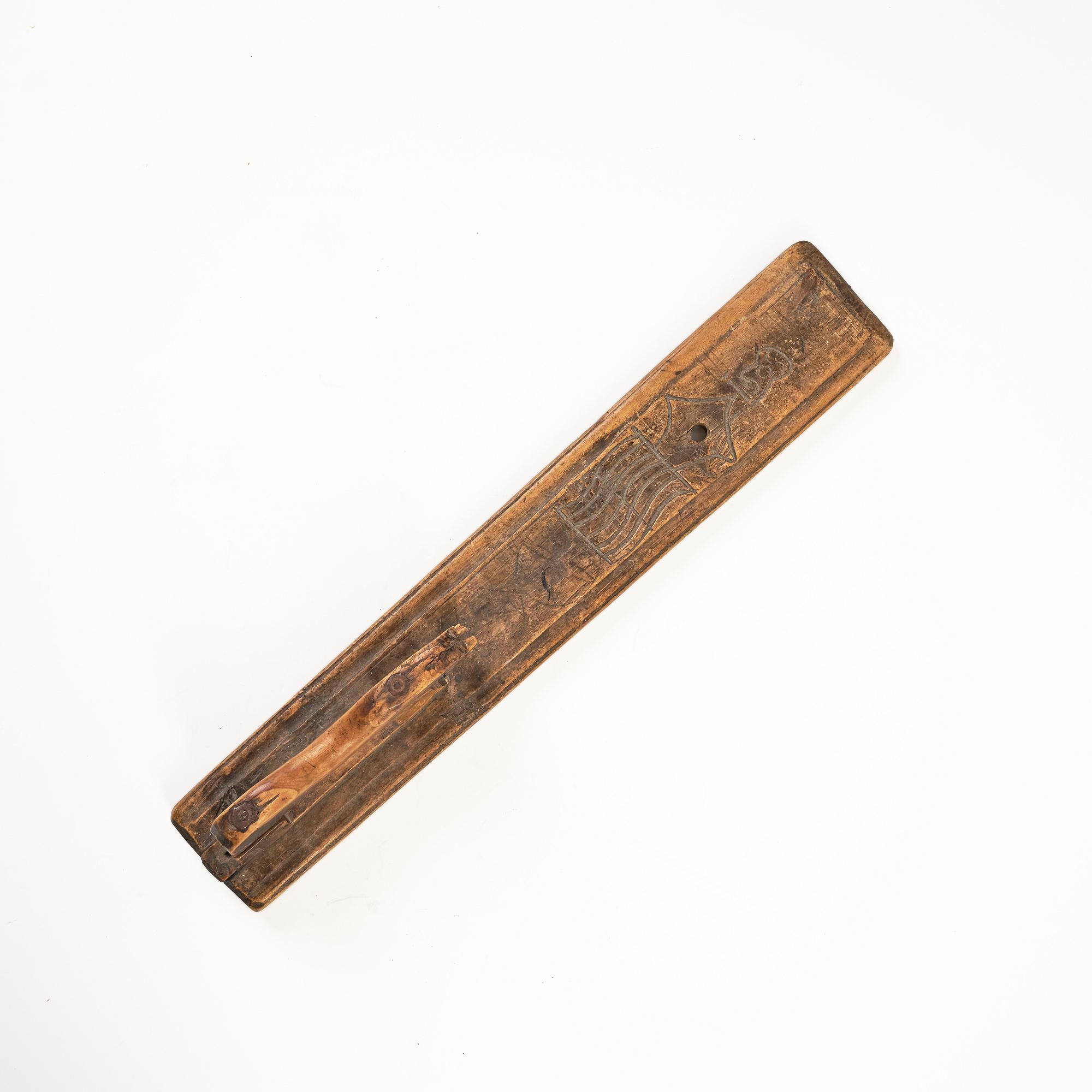 A Swedish folk art carved wringer, dated 1669.