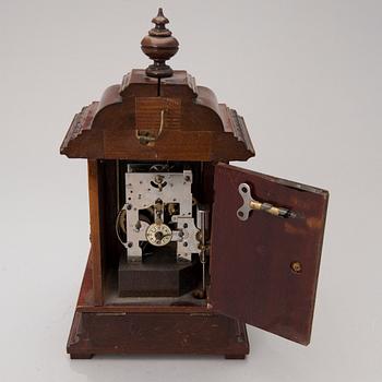 An early 20th century German Junghans table clock with music box.