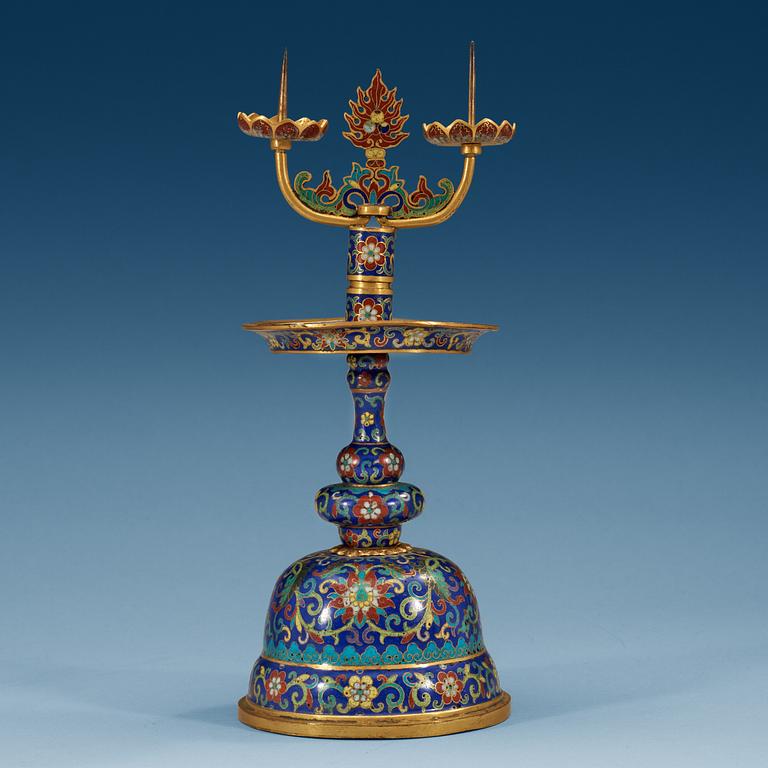 A fine Cloisonné candlestick holder with floral scrolls against a deep blue back ground, Qing dynasty, 18th Century.