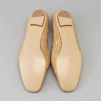 A pair of raffia shoes by Emma Hope's.