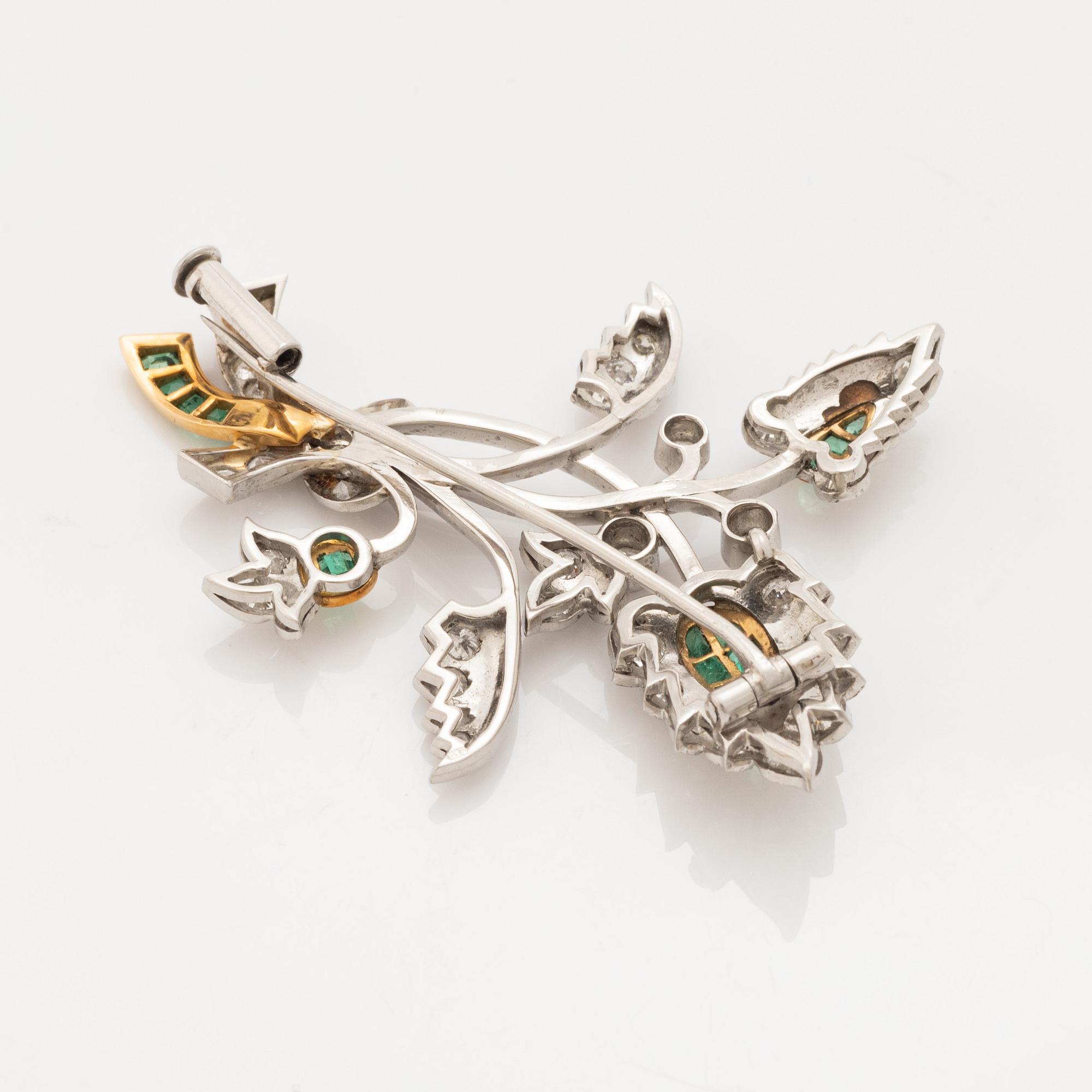 Platinum and gold with brilliant cut diamonds and emerald brooch.