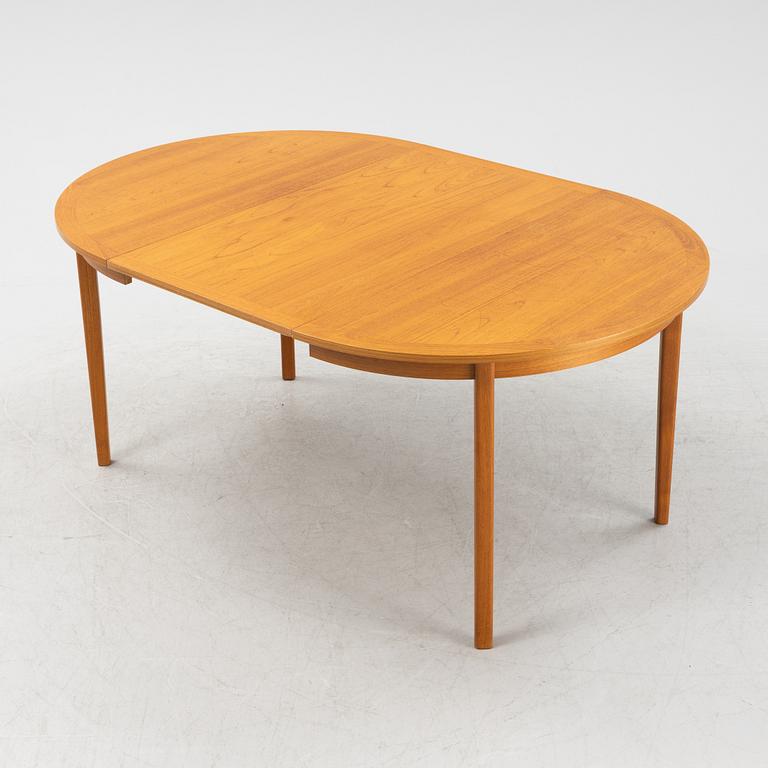 A teak veneer dining table from the mid 20th century.