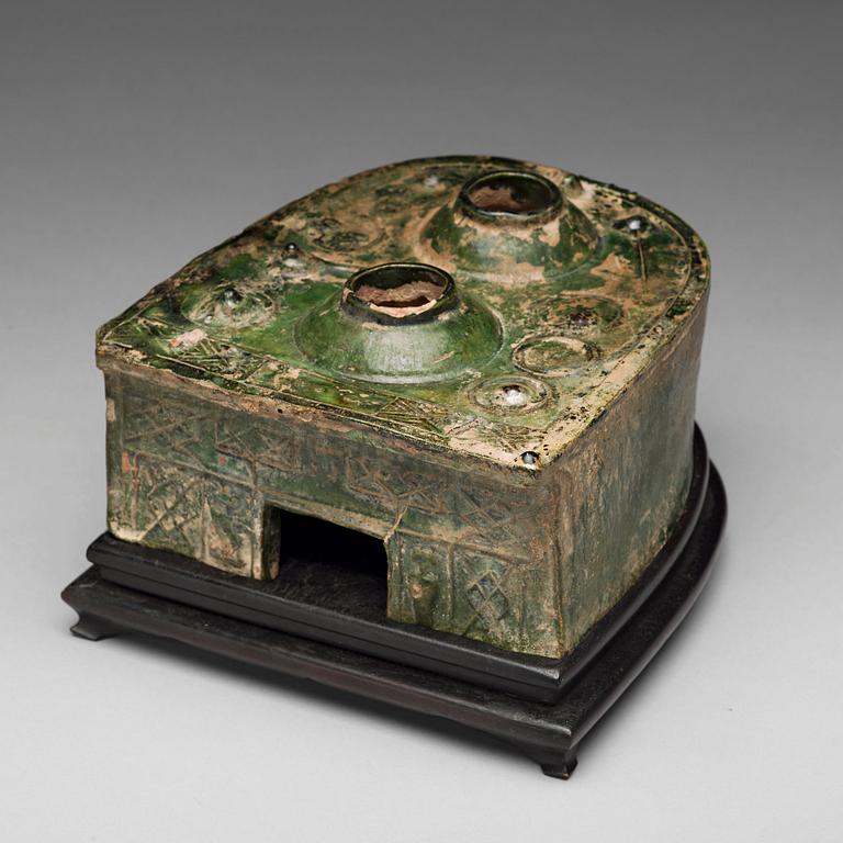 A green glazed pottery model of a stove, Han dynasty (206 BC-220 AD).