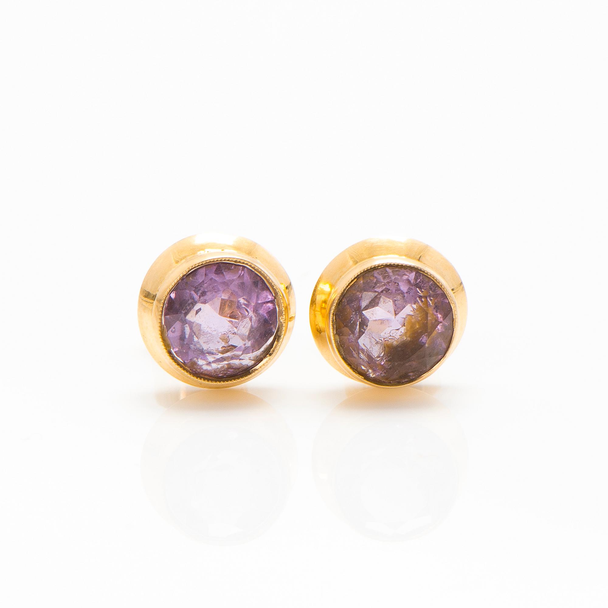 A set of 14K gold earrings and a ring with amethysts.