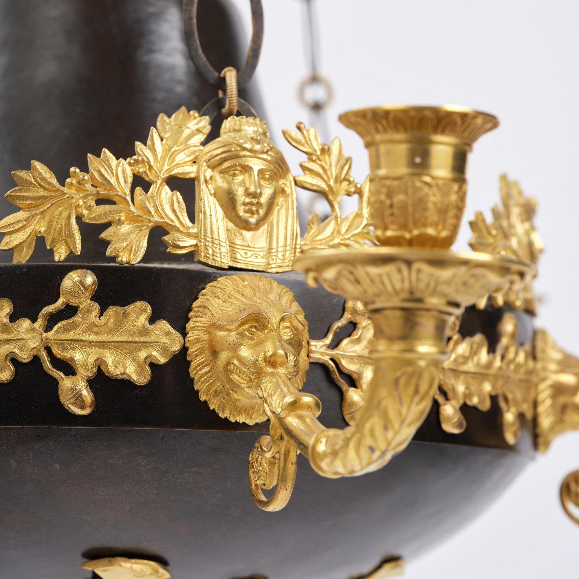A patinated and ormolu six-light Empire chandelier, Stockholm, first part 19th century.