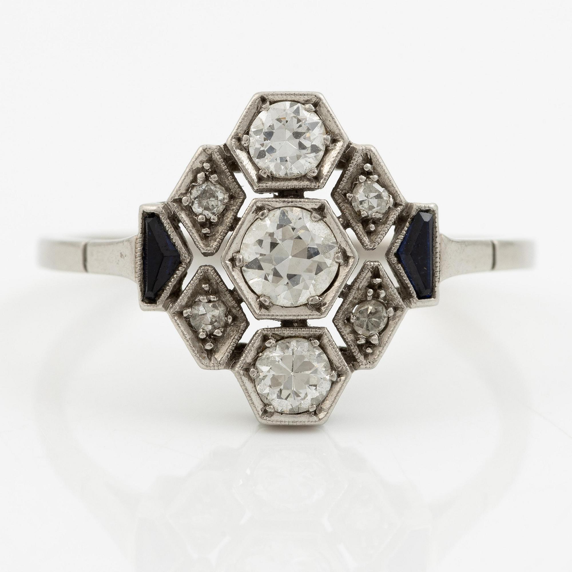 A platinum ring set with round brilliant-cut diamonds and sapphires, Art Déco.