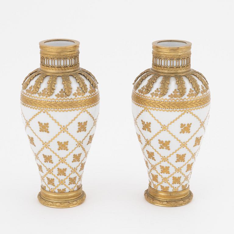 A pair of brass-mounted porcelain  vases, Sèvres mock marks, around 1900.