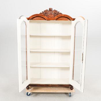 A walnut display cabinet around 1900.