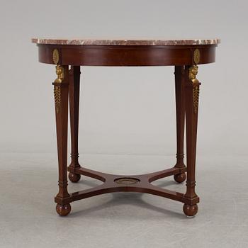 An empire-style table, early 20th century.