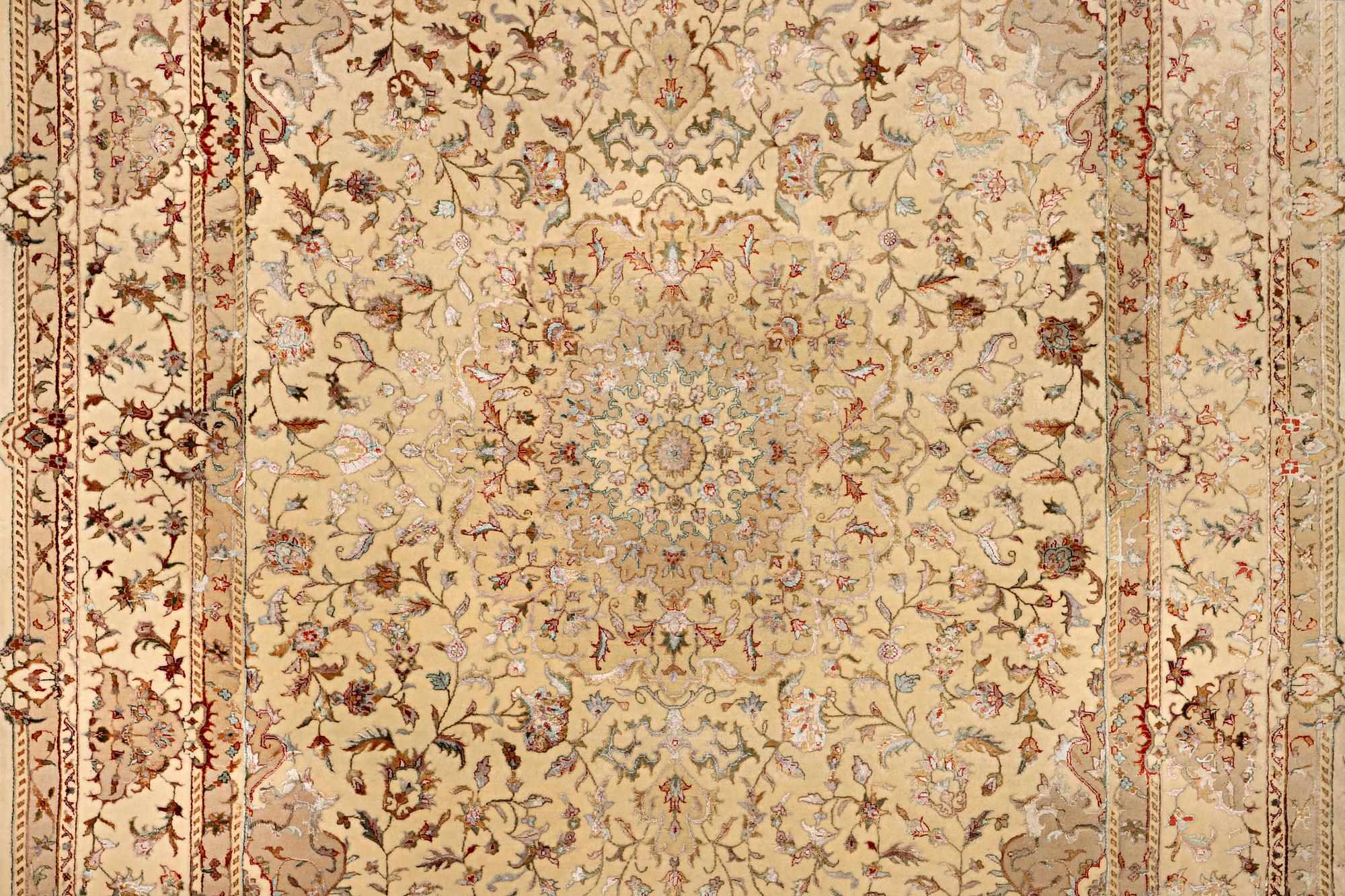 A Tabriz carpet, part silk, c. 311 x 199 cm.