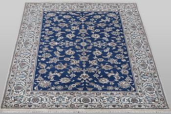 A carpet, Nain, part silk, ca 297 x 194 cm.