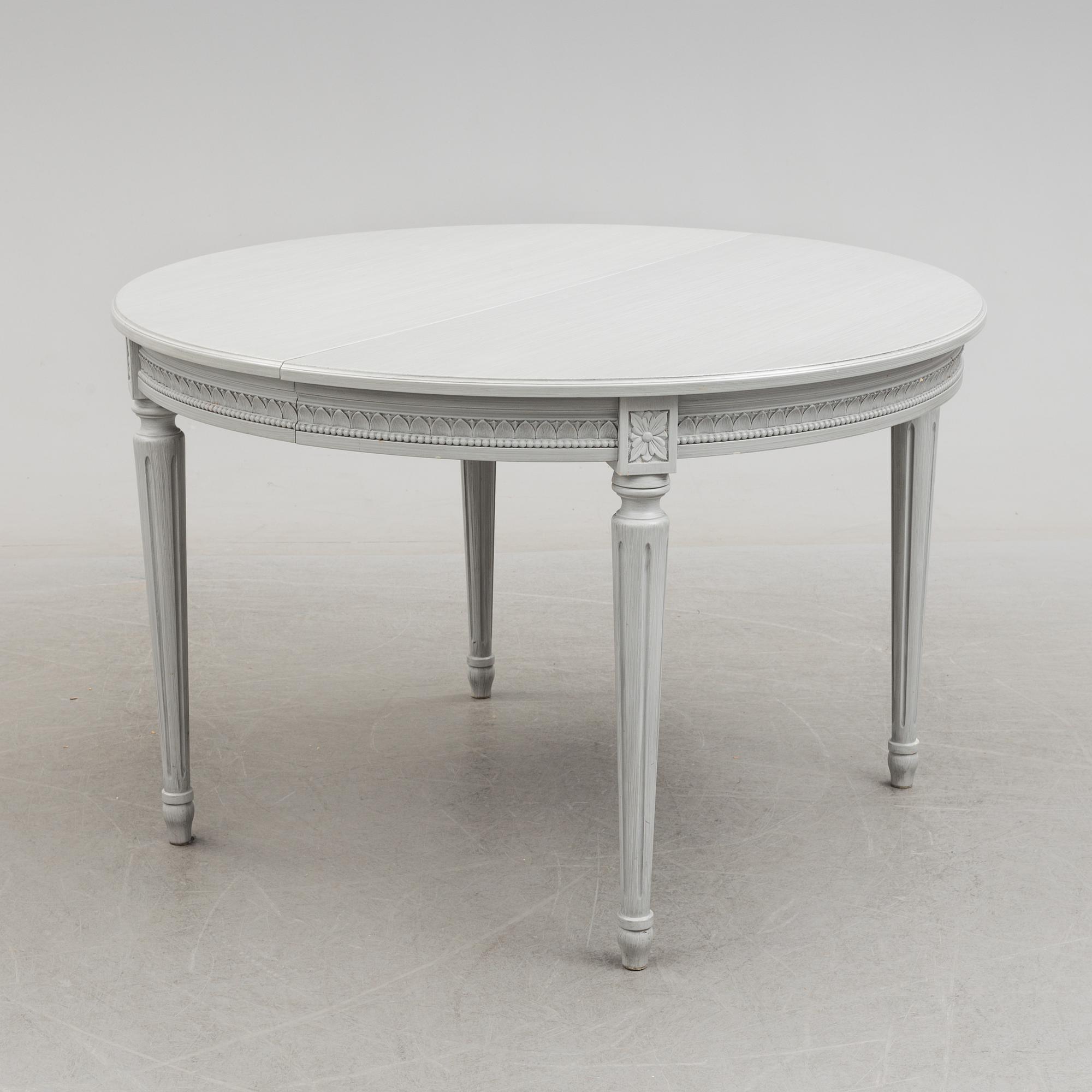 A Gustavian style dining table and ten chairs, 20th century.