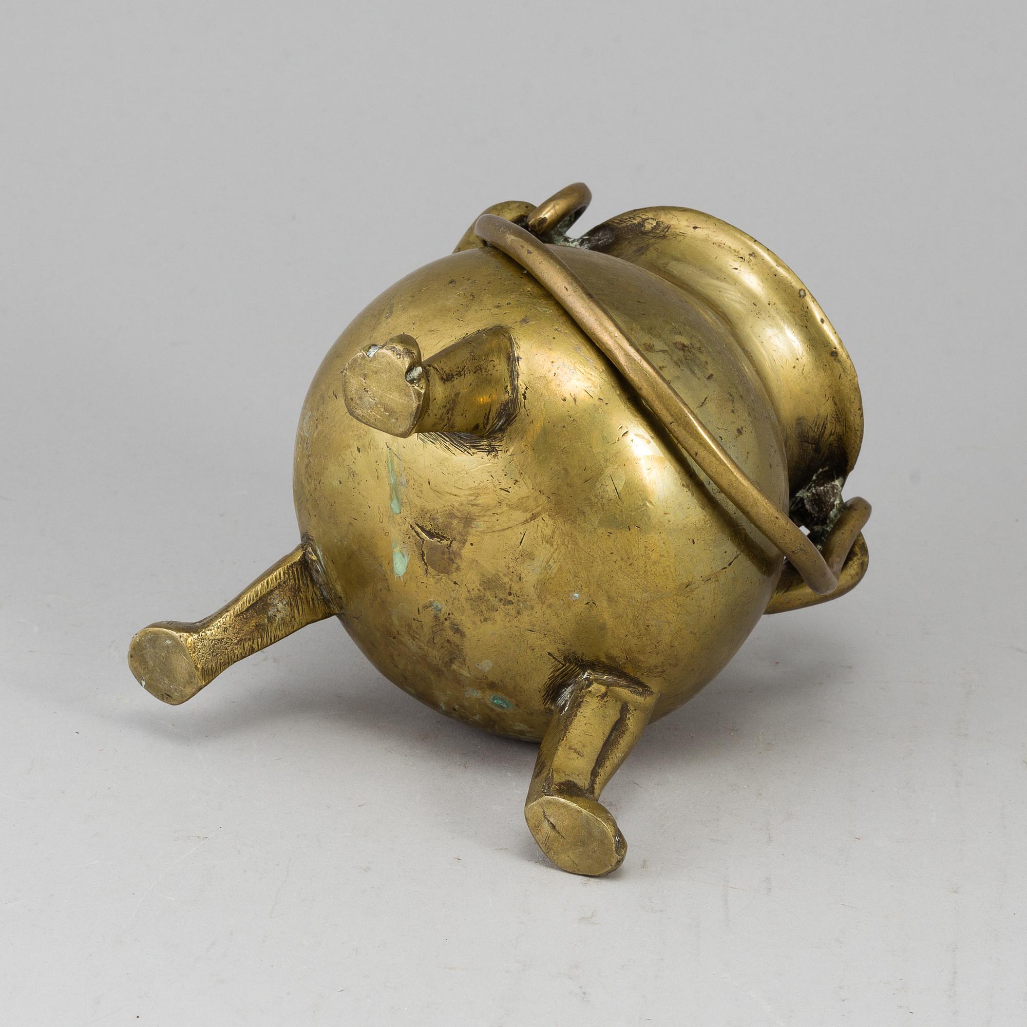 A 17th century brass bowl.