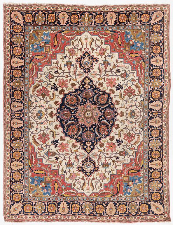 An antique Tabriz carpet, c. 365 x 280 cm.