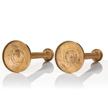 A pair of French Empire ormolu candlesticks, early 19th century.