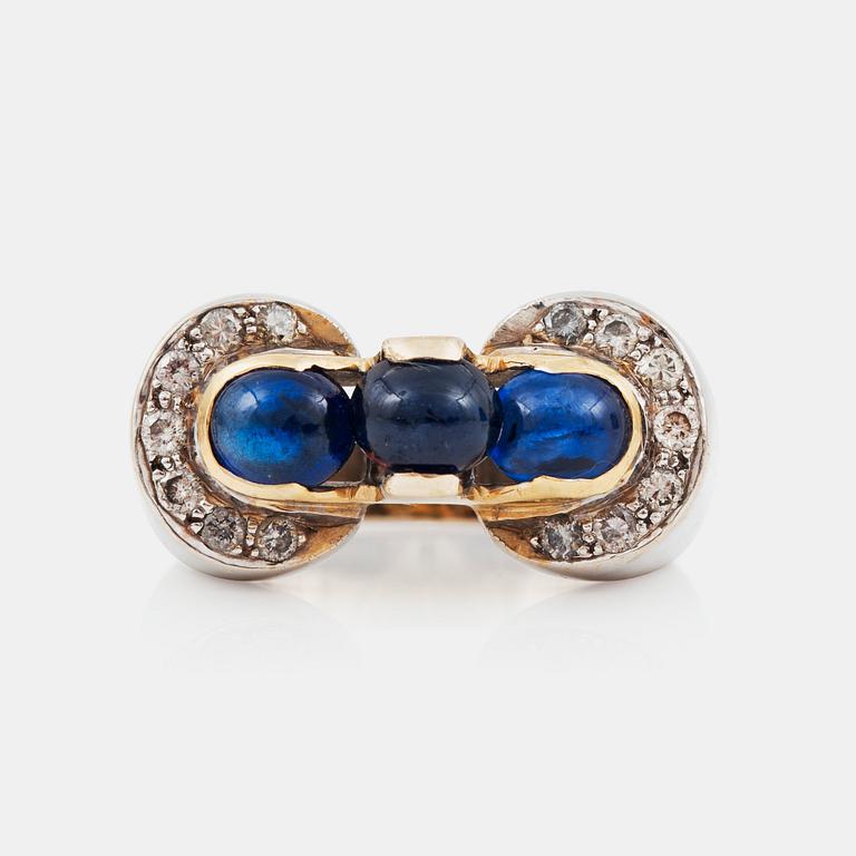 A cabochon-cut sapphire and brilliant-cut diamond ring.Total carat weight of diamonds circa 0.45 ct.