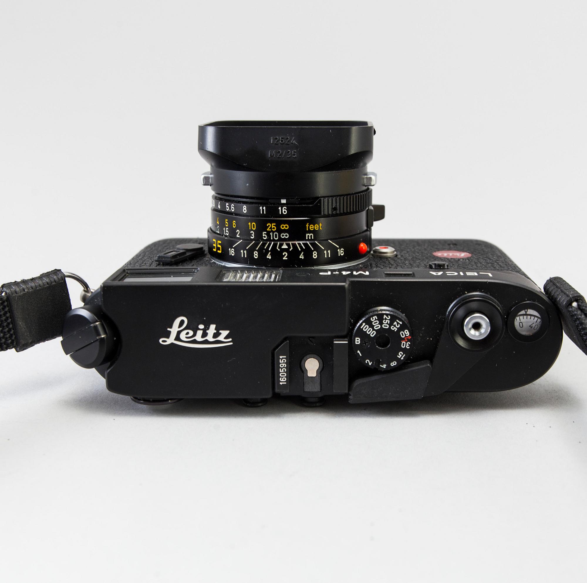 a black body Leica M4-P camera with no 1605951 made by Leitz Canada in 1982. With two lenses and a Leica Meter.