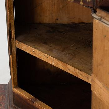 A Swedish corner cabinet dated 1784.