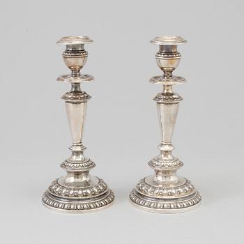 A pair of silver candle sticks, dated 1903.