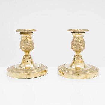 A pair of early 19th century French gilded Empire candlesticks.