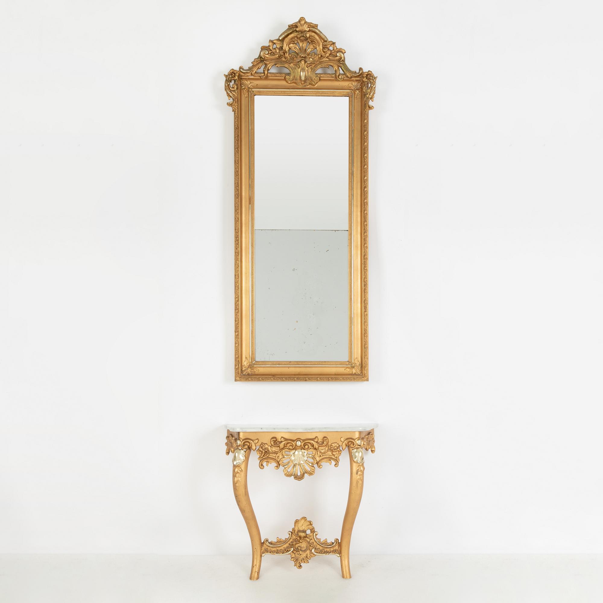A rococo-style mirror and console table, around 1900.