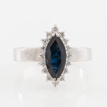 Ring 18K white gold set with a navette-cut sapphire and round brilliant-cut diamonds.