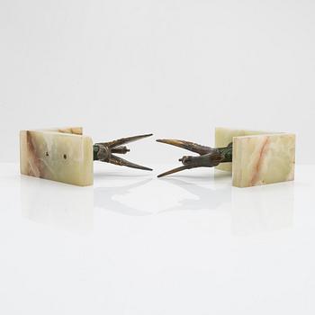 A pair of alabaster and  patinated metal Art Deco bookends from the first half of the 20th Century.