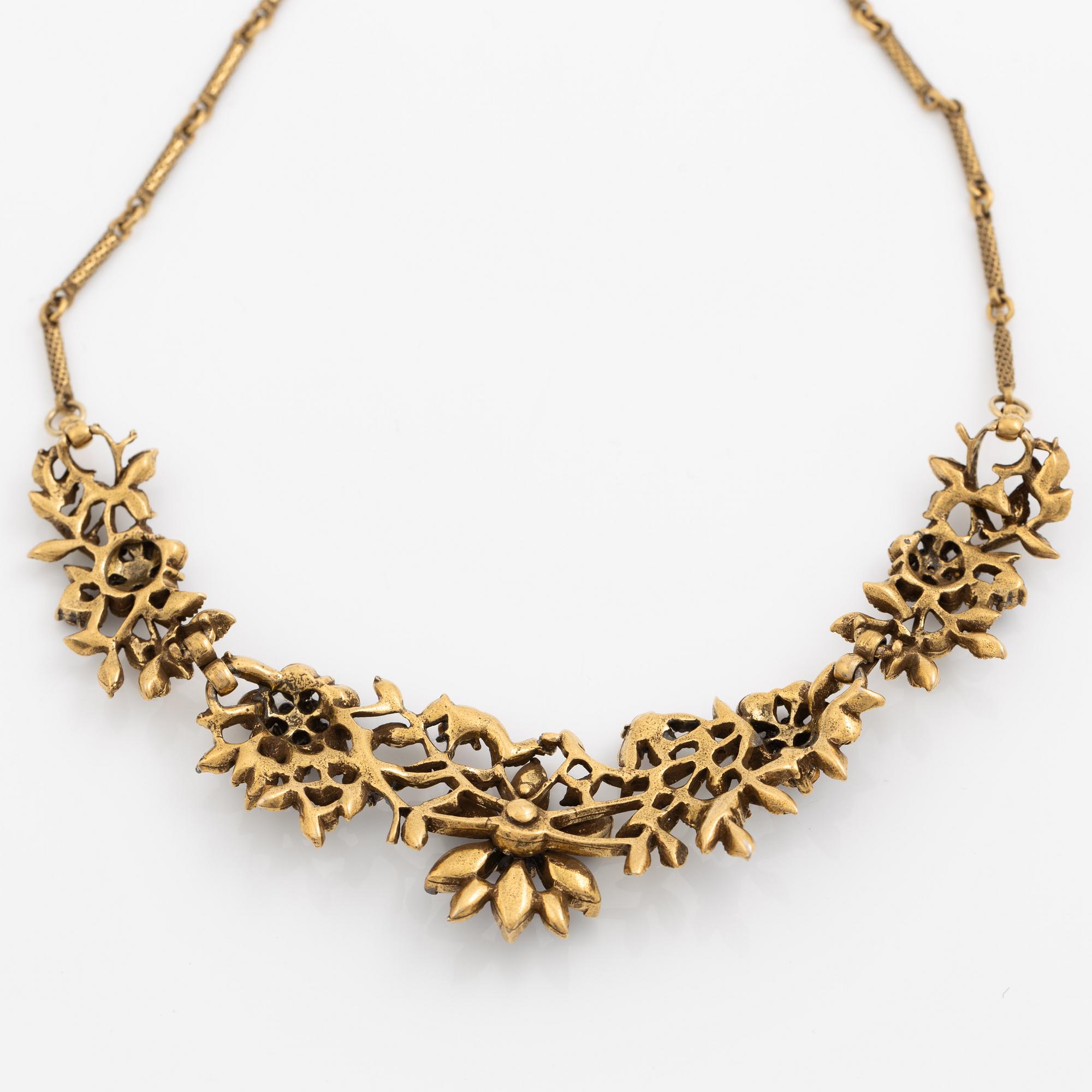 Necklace and brooch with purple stones.