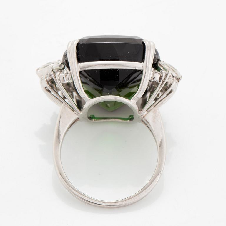 An 18K white gold ring set with a green tourmaline and round- and marquise brilliant-cut diamonds.