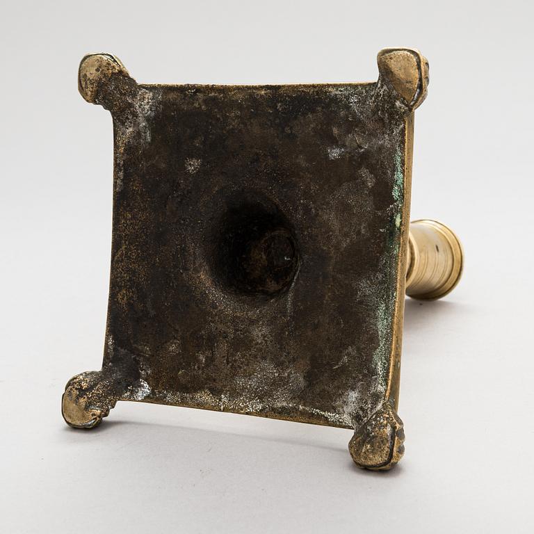 A late 17th century Spanish brass candlestick.