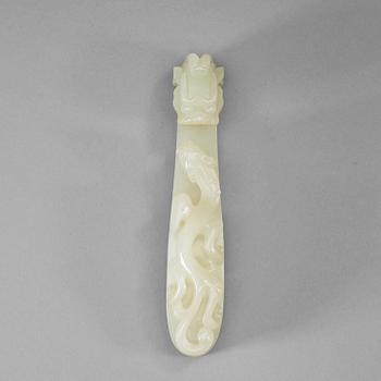 27. A carved white nephrite belt hook, Qing dynasty (1644-1912).