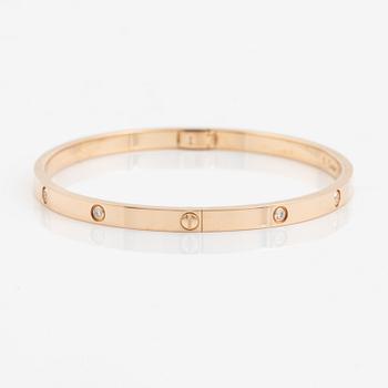 A Cartier "Love" bracelet small model in 18K rose gold with ten round brilliant-cut diamonds.