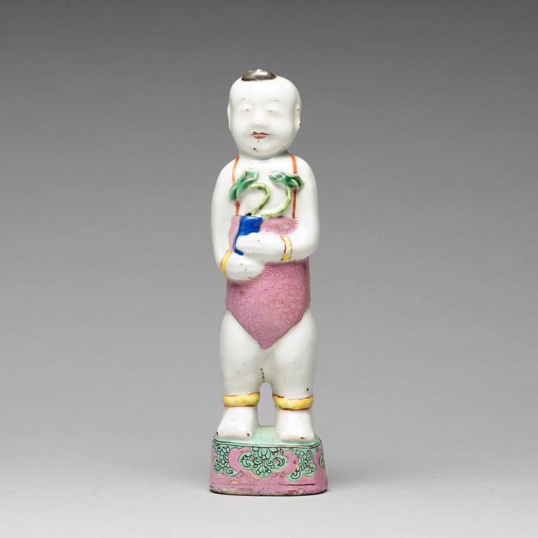 A famille rose porcelain figure of a laughing boy, Qing dynasty, 18th Century.