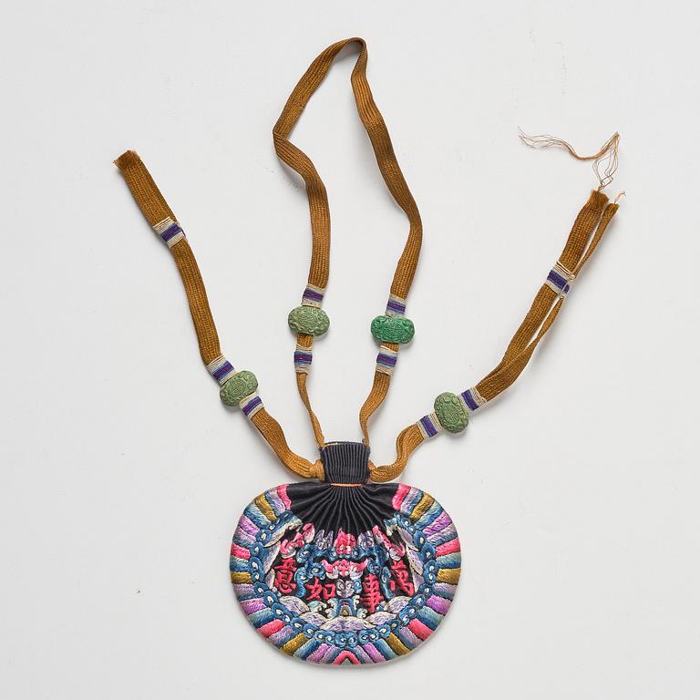 A set of three embroidered purses/ eye-glass cases, Qing dynasty, 19th century.