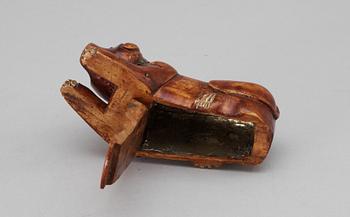 A 19th-20th century birch snuffbox in the shape of a lying dog.