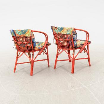 A pair of painted rattan armchairs possibly by Svenskt Tenn.
