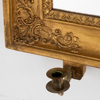 A first half of the 19th century mirror wall sconce.